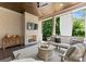 A well decorated covered porch with a fireplace, TV, comfortable seating, and wood ceiling at 1160 S Kings Dr, Charlotte, NC 28207