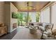 This covered porch features wood ceiling, fireplace, comfortable seating, and views of the backyard at 1160 S Kings Dr, Charlotte, NC 28207