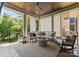 This covered porch features wood ceiling, comfortable seating, and a scenic view of the yard at 1160 S Kings Dr, Charlotte, NC 28207