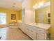 Bright primary bathroom with dual vanities, and a soaking tub for a relaxing retreat at 1209 S South St, Gastonia, NC 28052