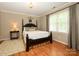 Cozy bedroom with hardwood floors, neutral walls, and abundant natural light creates a welcoming atmosphere at 1209 S South St, Gastonia, NC 28052