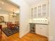 Butler's pantry featuring a wine cooler, wall cabinets with glass doors, and access to formal dining room at 1209 S South St, Gastonia, NC 28052