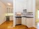 Butler's pantry featuring a wine cooler, cabinets, a sink, and access to other rooms at 1209 S South St, Gastonia, NC 28052