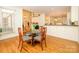 Dining area with hardwood floors, table with four chairs, and easy access to kitchen, and access to other rooms at 1209 S South St, Gastonia, NC 28052