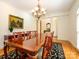 Formal dining room featuring a long wood table, elegant chandelier, and classic decor at 1209 S South St, Gastonia, NC 28052