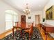 Elegant dining room with hardwood floors, a chandelier, and a large wooden table at 1209 S South St, Gastonia, NC 28052