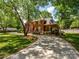 Stately brick home featuring a circular driveway and lush landscaping at 1209 S South St, Gastonia, NC 28052