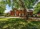 Beautiful brick home with manicured lawn and mature trees at 1209 S South St, Gastonia, NC 28052