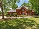 Attractive two-story brick home featuring a well-manicured lawn and mature trees at 1209 S South St, Gastonia, NC 28052