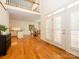 Inviting foyer with hardwood floors, staircase with wood railing, and double doors that let in an abundance of natural light at 1209 S South St, Gastonia, NC 28052