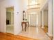 Bright foyer with tile flooring, a high ceiling, and a decorative wooden console table at 1209 S South St, Gastonia, NC 28052