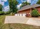 Spacious three-car garage with a large concrete driveway and brick exterior at 1209 S South St, Gastonia, NC 28052