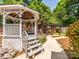 Gazebo with seating is surrounded by landscaping and a brick privacy fence at 1209 S South St, Gastonia, NC 28052