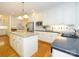 Well-equipped kitchen with stainless steel appliances, kitchen island, white cabinets, and black countertops at 1209 S South St, Gastonia, NC 28052