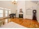 Comfortable living room with hardwood floors, fireplace, built-ins, and a grand piano at 1209 S South St, Gastonia, NC 28052