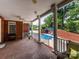Covered patio with brick flooring overlooks the pool with ceiling fans for added comfort at 1209 S South St, Gastonia, NC 28052