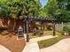 Outdoor pergola and brick fireplace create an inviting outdoor living area at 1209 S South St, Gastonia, NC 28052