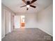 Bright bedroom featuring neutral walls, carpeted floors, and a ceiling fan at 12231 Stratfield Place Cir, Pineville, NC 28134