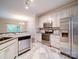 Bright kitchen with stainless steel appliances and white cabinets and tile floors at 12231 Stratfield Place Cir, Pineville, NC 28134