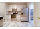 Bright kitchen with stainless steel appliances, white cabinets, and updated tile flooring at 12231 Stratfield Place Cir, Pineville, NC 28134