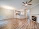 Spacious living room featuring luxury vinyl plank floors, a fireplace, and modern lighting at 12231 Stratfield Place Cir, Pineville, NC 28134