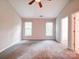 Bright main bedroom featuring neutral walls, two windows, and plush carpeting throughout at 12231 Stratfield Place Cir, Pineville, NC 28134