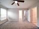 Comfortable carpeted main bedroom with a ceiling fan and ample natural light from a large window at 12231 Stratfield Place Cir, Pineville, NC 28134