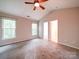 Inviting main bedroom with a ceiling fan, neutral walls, and plush carpeting for added comfort at 12231 Stratfield Place Cir, Pineville, NC 28134