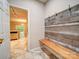 Mud room entrance with a built-in bench, hooks, and direct access to the kitchen at 12231 Stratfield Place Cir, Pineville, NC 28134