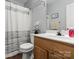 Bathroom featuring a vanity with wood cabinets and a shower with glass doors at 1410 Swaying Branch Ln, Clover, SC 29710
