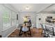 Cozy dining room with natural light showcases the breakfast bar and white appliances at 1410 Swaying Branch Ln, Clover, SC 29710