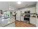 Well-lit kitchen boasts stainless steel appliances, granite countertops and wood flooring at 1410 Swaying Branch Ln, Clover, SC 29710