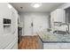 Bright kitchen features white cabinets, granite countertops, stainless appliances and wood floors at 1410 Swaying Branch Ln, Clover, SC 29710