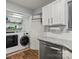 Adjacent to the kitchen, the laundry area provides granite countertops, cabinetry and washer/dryer at 1410 Swaying Branch Ln, Clover, SC 29710