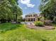 Expansive backyard view with pool, lush landscaping and inviting outdoor space at 1509 Churchill Downs Dr, Waxhaw, NC 28173