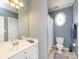 Well-lit bathroom featuring a white vanity and a separate toilet area at 1509 Churchill Downs Dr, Waxhaw, NC 28173