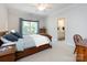 Cozy bedroom with soft bedding, a wooden bed frame, a ceiling fan, and an ensuite bathroom at 1509 Churchill Downs Dr, Waxhaw, NC 28173