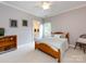 Relaxing bedroom with a wooden bed frame, neutral walls, ceiling fan, and an ensuite bathroom at 1509 Churchill Downs Dr, Waxhaw, NC 28173