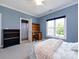 Bedroom with bed, desk, bookshelves, and open bathroom doorway at 1509 Churchill Downs Dr, Waxhaw, NC 28173