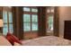 Bright bedroom featuring large windows with shutters, access to the pool, and calming neutral decor at 1509 Churchill Downs Dr, Waxhaw, NC 28173