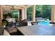 Serene covered patio with comfortable seating, outdoor dining area, fireplace, and a soothing view of the pool at 1509 Churchill Downs Dr, Waxhaw, NC 28173