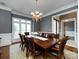 Formal dining room boasts a large window, chandelier, and an elegant table setting for gatherings at 1509 Churchill Downs Dr, Waxhaw, NC 28173