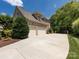 Large brick home with a spacious driveway and a three-car garage at 1509 Churchill Downs Dr, Waxhaw, NC 28173