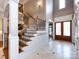 Elegant foyer features a grand staircase, marble floors, and a glimpse of the home's open layout at 1509 Churchill Downs Dr, Waxhaw, NC 28173