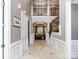 Spacious foyer with detailed trim, tiled floors, and a view into the living spaces beyond at 1509 Churchill Downs Dr, Waxhaw, NC 28173