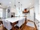 Large kitchen island with counter seating, pendant lights, modern appliances, and white cabinetry at 1509 Churchill Downs Dr, Waxhaw, NC 28173