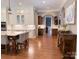 Spacious kitchen featuring white cabinets, subway tile backsplash, a large island, and hardwood floors at 1509 Churchill Downs Dr, Waxhaw, NC 28173