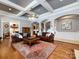 Elegant living room featuring hardwood floors, coffered ceilings and arched doorways offer a seamless transition at 1509 Churchill Downs Dr, Waxhaw, NC 28173