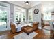 Cozy living area features an eat-in kitchen space with stainless steel appliances, large windows, and a corner sofa at 1509 Churchill Downs Dr, Waxhaw, NC 28173