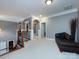 Upstairs loft area featuring neutral carpet, grey walls, accent columns, and a comfortable seating area at 1509 Churchill Downs Dr, Waxhaw, NC 28173